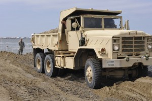PHOTO - Louisiana National Guard dumping sand to keep oil from inlet near Eden Island, LA