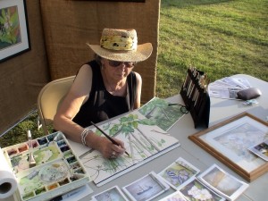 Polly Meltzer at work on watercolor painting of river flora and sun turtle.