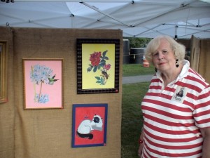 Framingham Artist Guild Member Merrillee Torres poses with some of her latest works, August 12, 2011