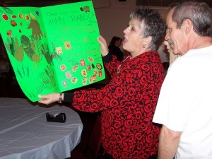 Karen & Mark Curtis looking over a ''Thank You'' card made by Framingham Girls Scouts.