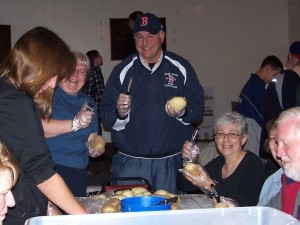 People from all walks of life, roll up their sleeve and help peel potatoes, cut carrots and get the massive amount of food read for the Thanksgiving dinner.